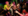 Women in 90s outfits dance in a club